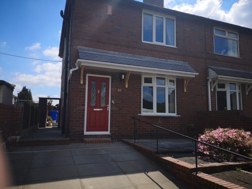 elite upvc- Porch With black grain roofline and composite door